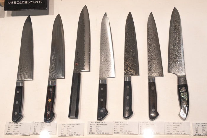 a person cleaning a knife on a cloth