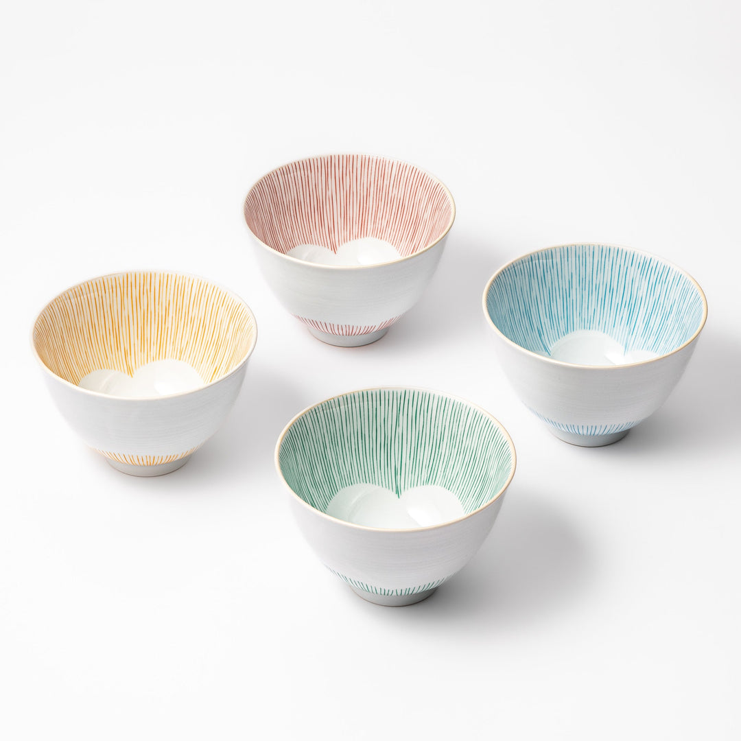 Set of four Japanese ceramic rice bowls with plum petal stripe design in red, blue, green, and orange, blending tradition and modern style