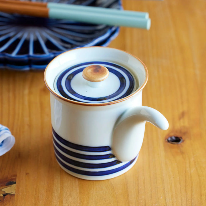 Japanese ceramic soy sauce dispenser with lid and indigo blue stripes ideal for authentic tableware use.