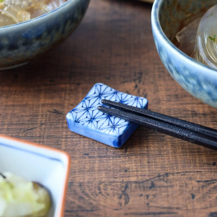 Square ceramic chopstick rest with Japanese blue hemp leaf pattern adding elegance to table presentation.