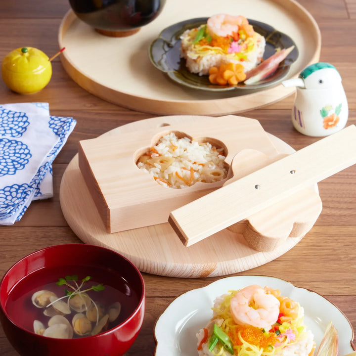 Hinoki onigiri mold in plum blossom shape, perfect for pressing rice into floral forms with a light, natural aroma.