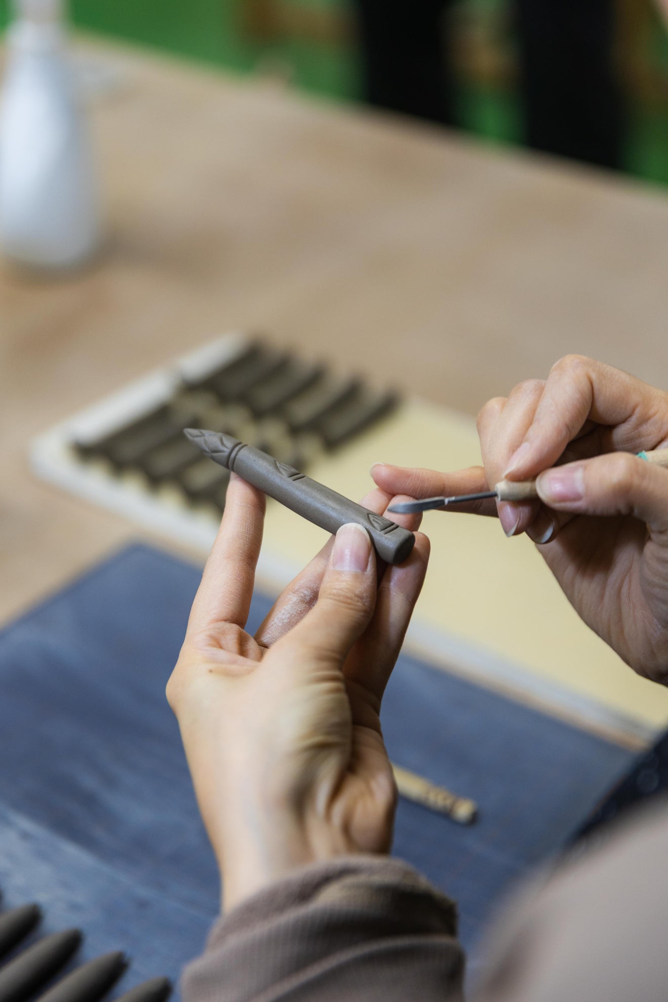 Ceramic asparagus chopstick rest handcrafted by Ihoshiro Kiln being carved by hand in a Japanese pottery studio