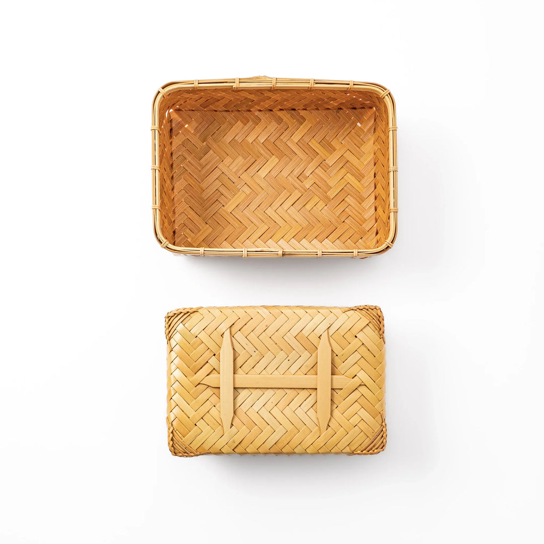 Traditional Japanese Ajiro weave bamboo bento box with a fitted lid showing intricate handcrafted diagonal patterns