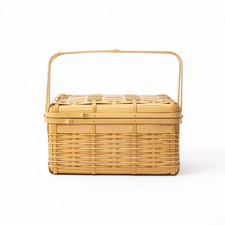 Large Japanese bamboo picnic basket with a sturdy arched handle and a fitted lid for outdoor dining and storage