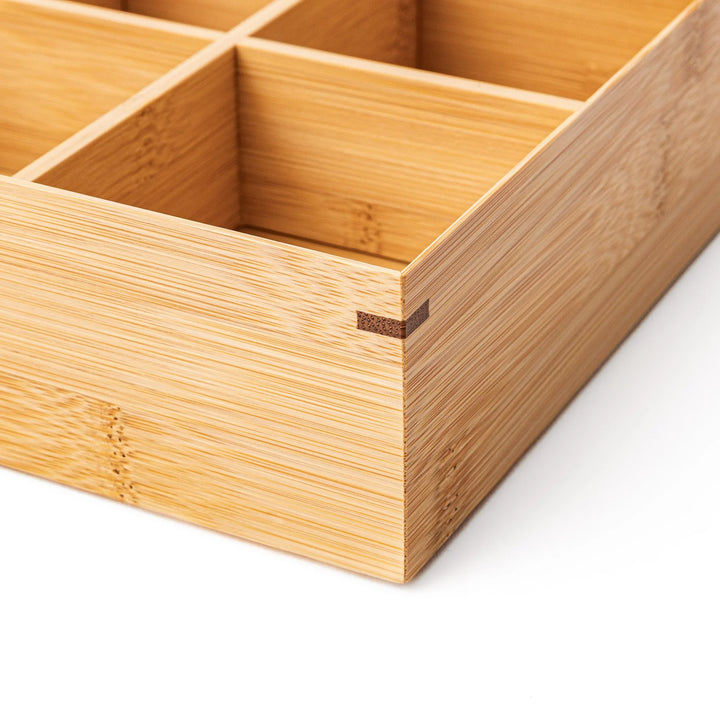 A rectangular bamboo bento box showing a smooth natural wood grain finish and a minimalist eco friendly design