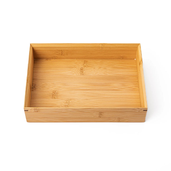 A rectangular bamboo bento box showing a smooth natural wood grain finish and a minimalist eco friendly design