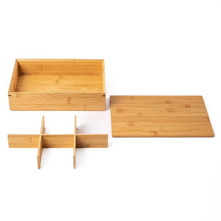 A disassembled bamboo bento box with the removable grid divider and lid taken out to demonstrate easy cleaning and versatility