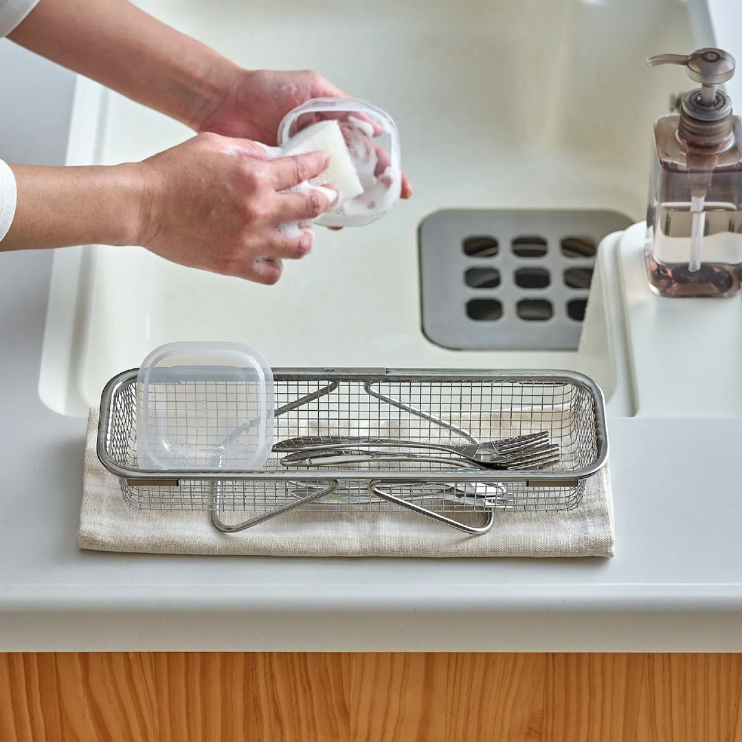 Stainless steel rectangular strainer basket with handles for draining noodles or frying in Japanese cooking.