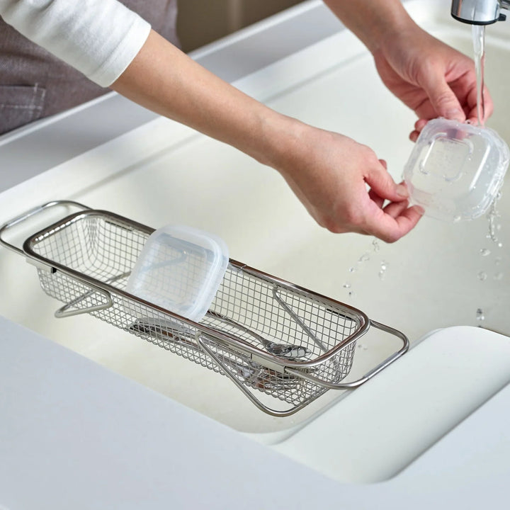 Stainless steel rectangular strainer basket with handles for draining noodles or frying in Japanese cooking.