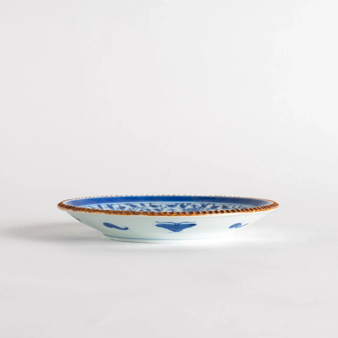 Ceramic plate with blue floral circular motif framed by copper textured rim for elegant Japanese dining.