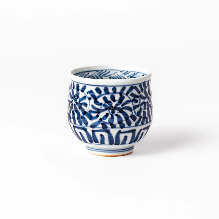 Porcelain sake cup featuring intricate blue landscape and arabesque patterns with a traditional hand-painted indigo design.