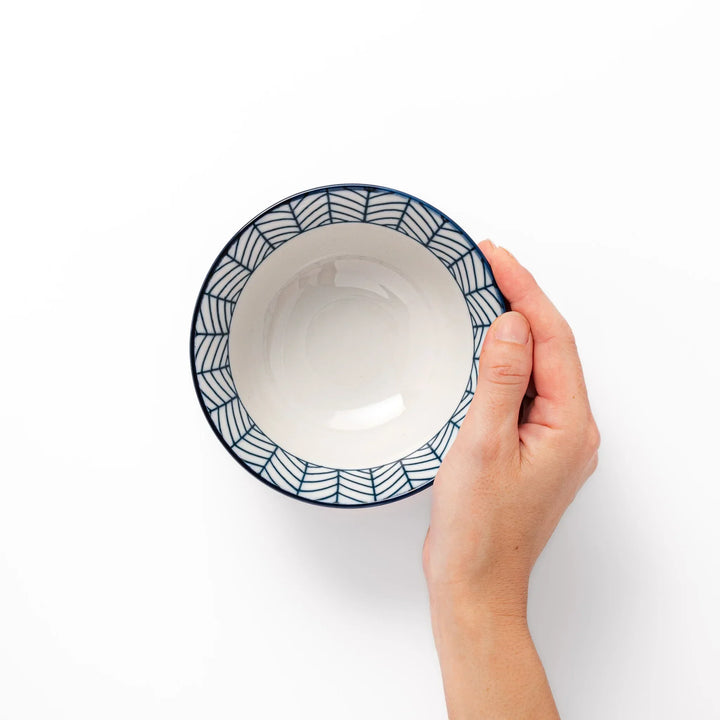 Japanese porcelain rice bowl with indigo arrow feather pattern and terracotta base, handcrafted in traditional style.