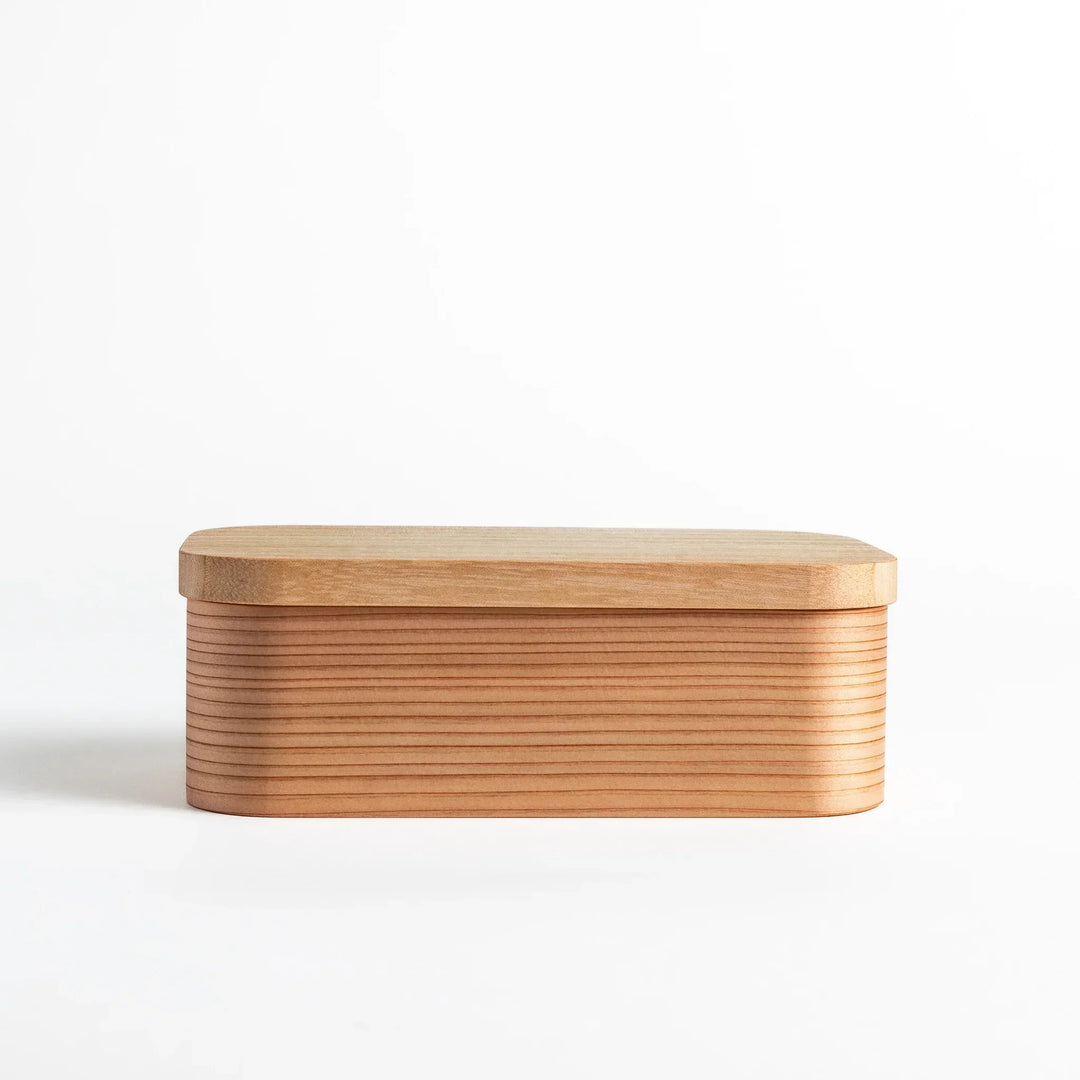 Artisan Cedar Bento Box with lid on, showcasing the natural cedar wood grain and rounded edges for a minimalist and elegant look.