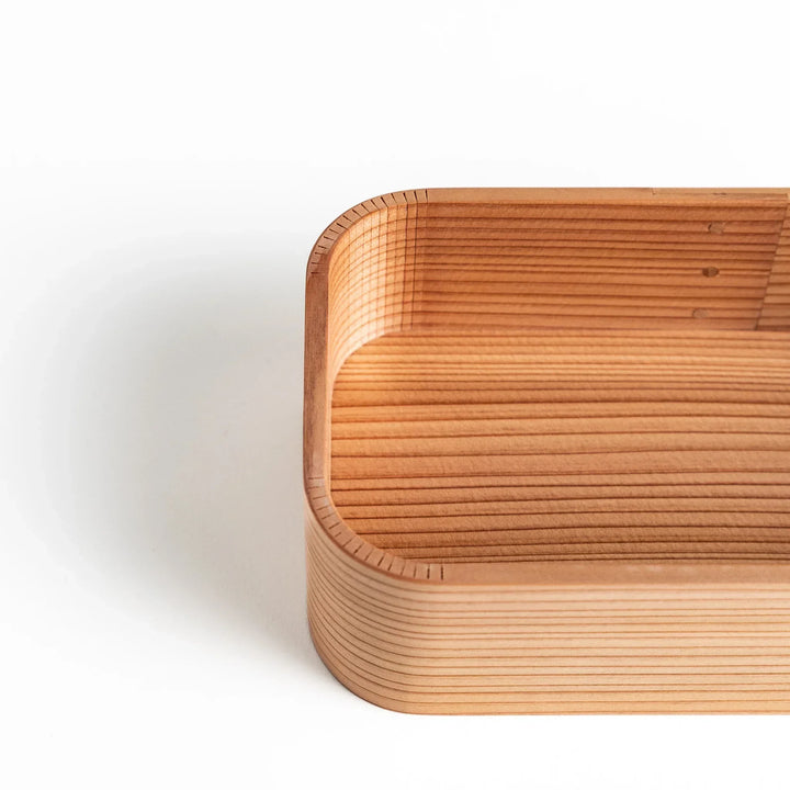 Close-up of Artisan Cedar Bento Box, showing detailed wood grain and the neat finish along the edges.