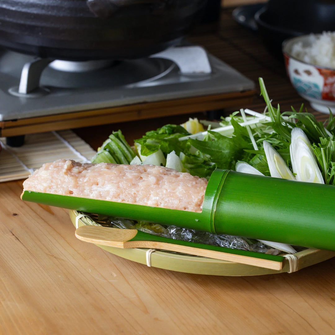 Japanese bamboo tsumire serving set loaded with chicken meatballs for healthy hot pot dinner on a cozy table