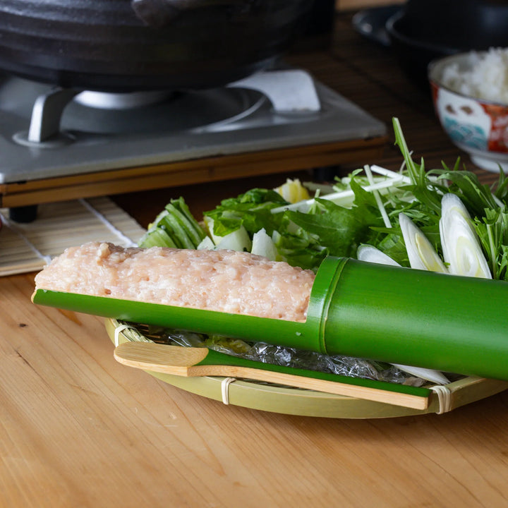 Japanese bamboo tsumire serving set loaded with chicken meatballs for healthy hot pot dinner on a cozy table