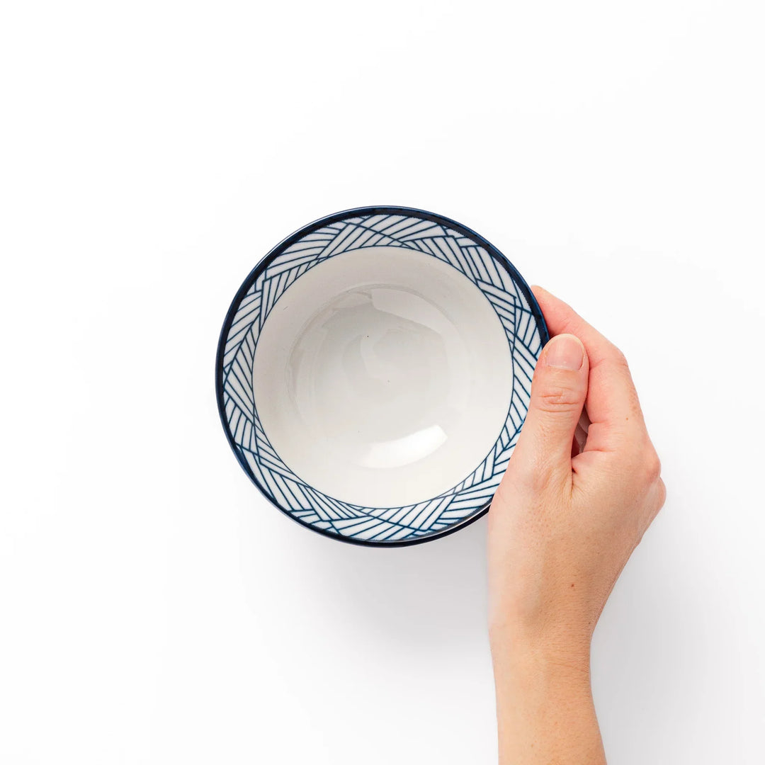 Japanese porcelain rice bowl with indigo basket weave pattern and terracotta base, crafted in traditional style.