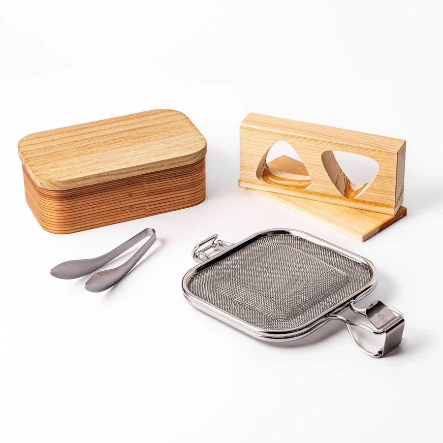 Japanese bento set with wooden lunch box onigiri mold grill mesh and tongs for easy homemade lunches.