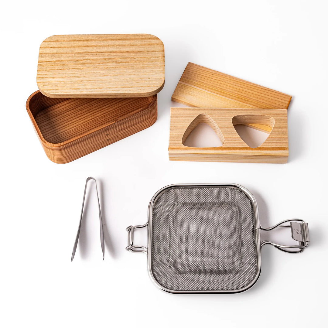 Japanese bento set with wooden lunch box onigiri mold grill mesh and tongs for easy homemade lunches.