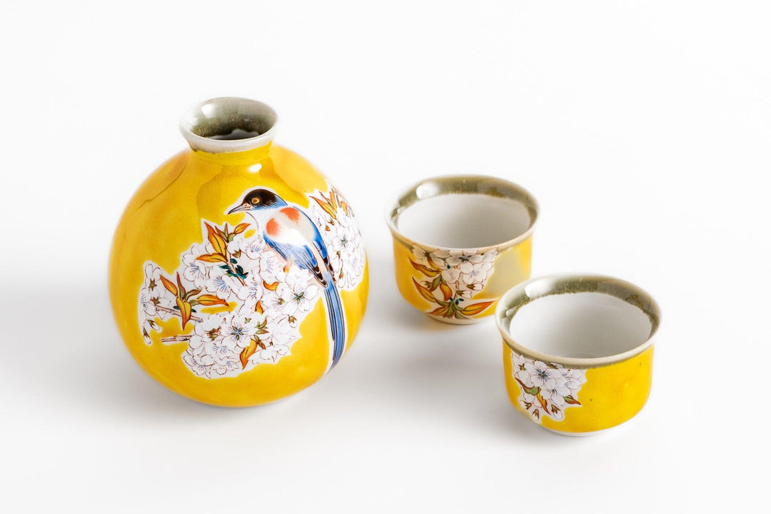 Yellow porcelain sake set with hand painted bird and cherry blossom design from Japan