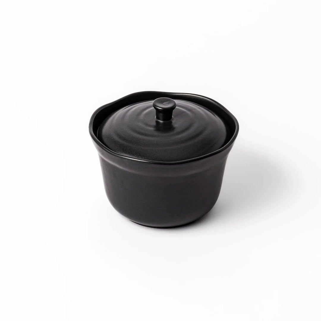 Black ceramic rice storage bowl with floral ridge lid design, compact size for storing cooked rice and keeping it warm.