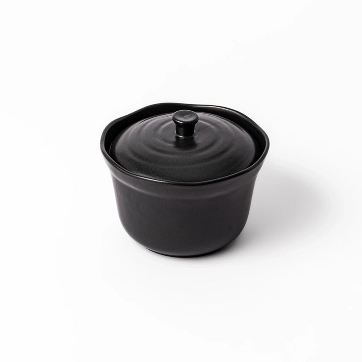 Black ceramic rice storage bowl with floral ridge lid design, compact size for storing cooked rice and keeping it warm.