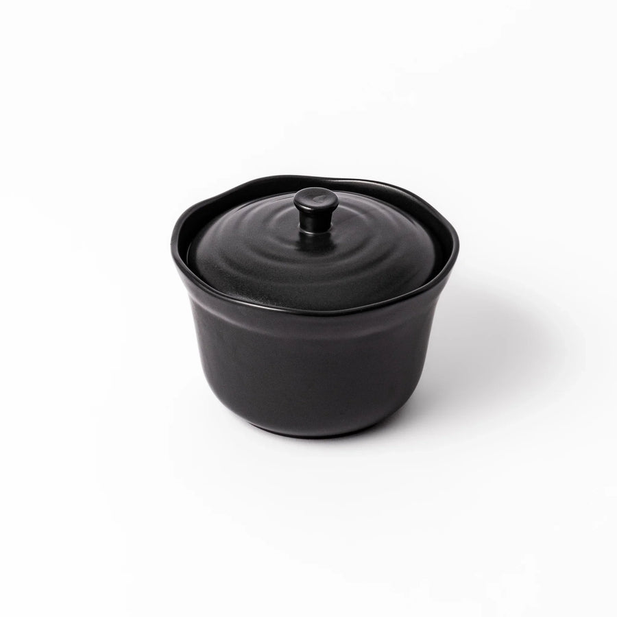 Black ceramic rice storage bowl with floral ridge lid design, compact size for storing cooked rice and keeping it warm.