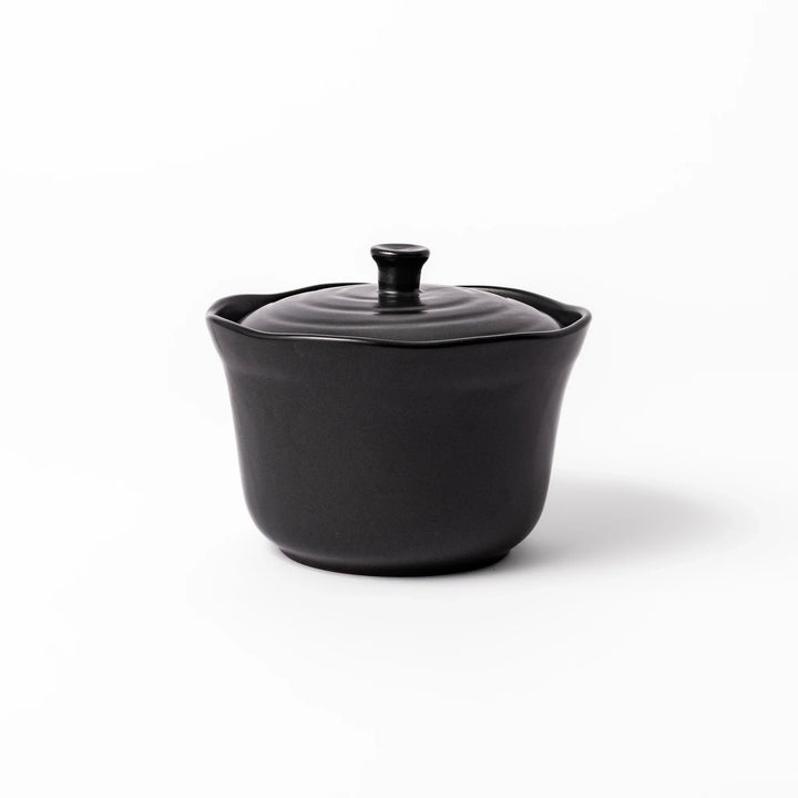 Black ceramic rice storage bowl with floral ridge lid design, compact size for storing cooked rice and keeping it warm.