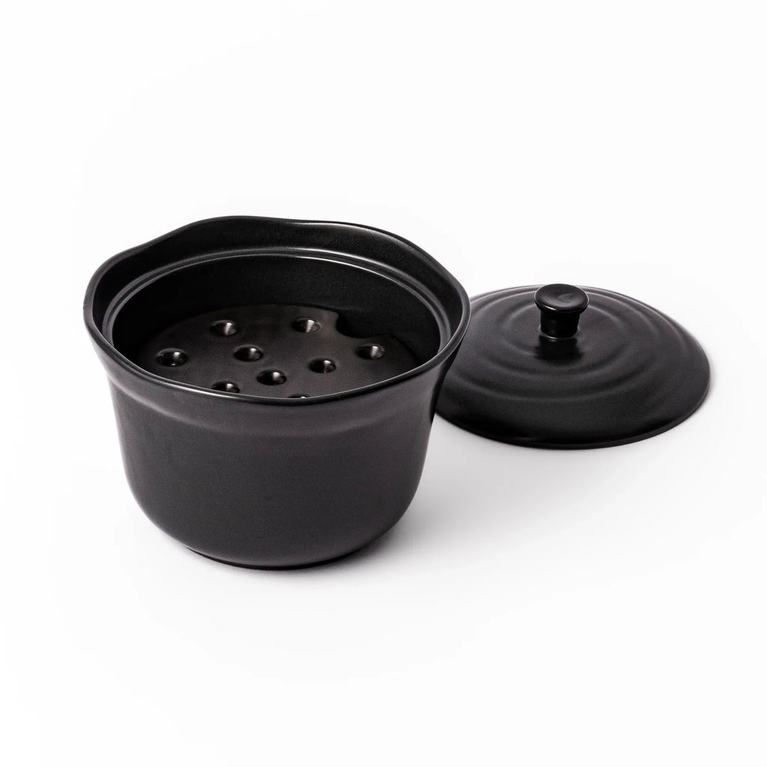 Black ceramic rice storage bowl with floral ridge lid design, compact size for storing cooked rice and keeping it warm.