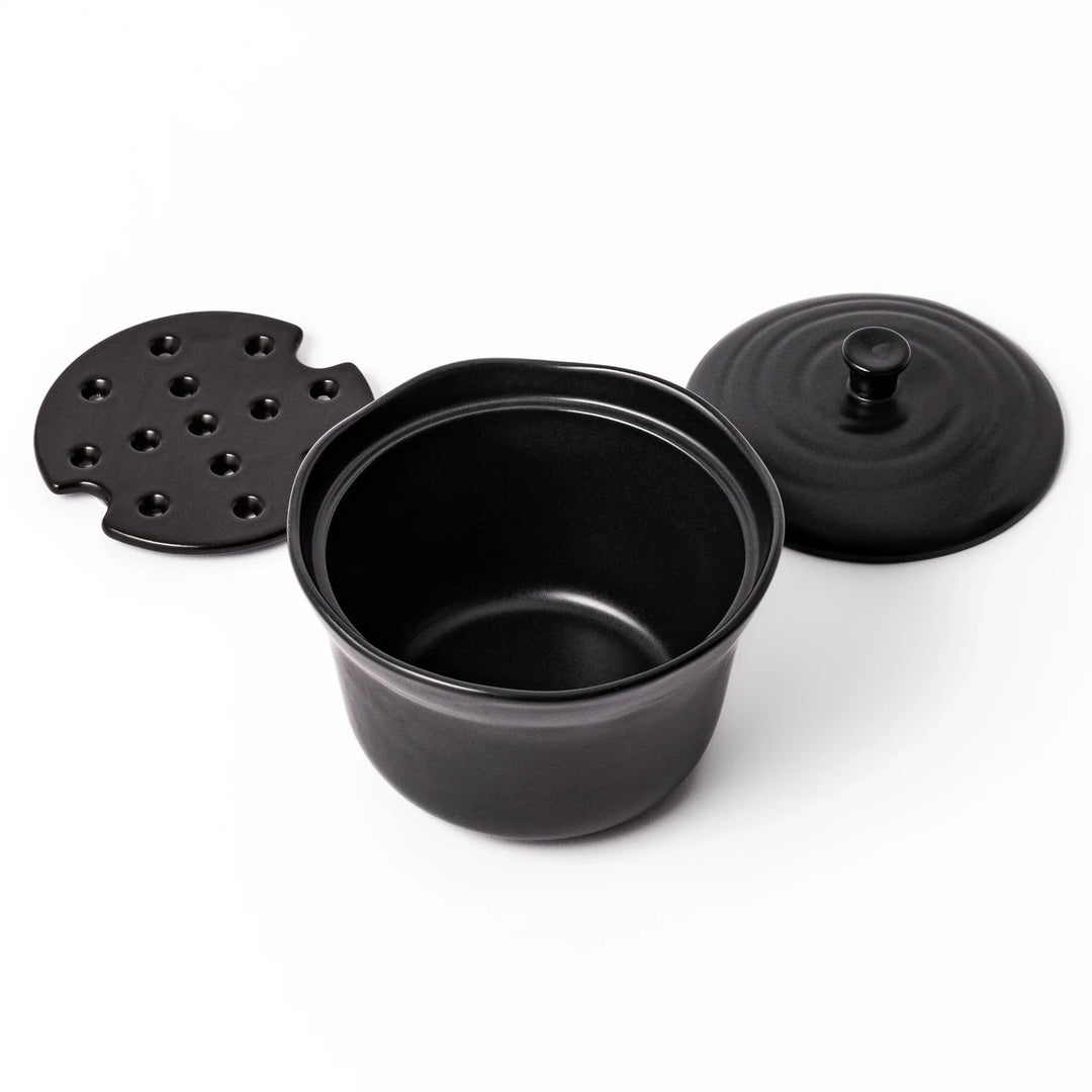 Black ceramic rice storage bowl with floral ridge lid design, compact size for storing cooked rice and keeping it warm.
