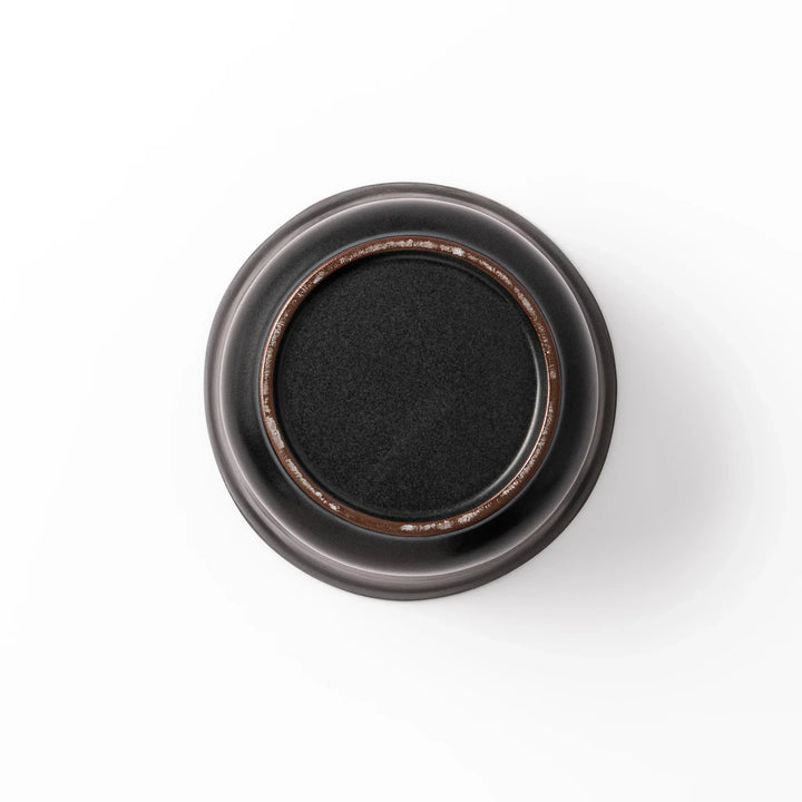 Black ceramic rice storage bowl with floral ridge lid design, compact size for storing cooked rice and keeping it warm.