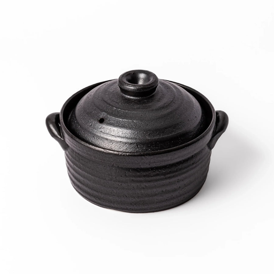 Black clay donabe with induction-compatible design, featuring double lid and side handles, ideal for cooking 2 cups of rice.