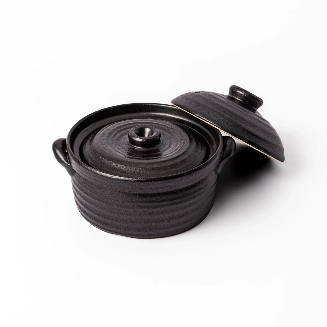 Black clay donabe with induction-compatible design, featuring double lid and side handles, ideal for cooking 2 cups of rice.