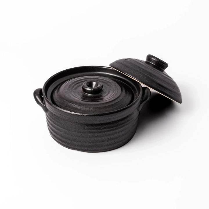 Black clay donabe with induction-compatible design, featuring double lid and side handles, ideal for cooking 2 cups of rice.