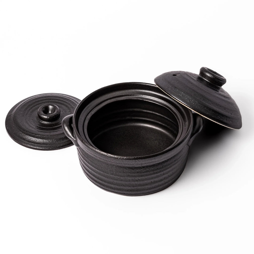 Black clay donabe with induction-compatible design, featuring double lid and side handles, ideal for cooking 2 cups of rice.