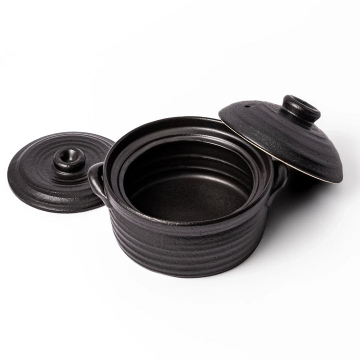 Black clay donabe with induction-compatible design, featuring double lid and side handles, ideal for cooking 2 cups of rice.