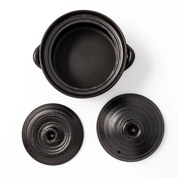 Black clay donabe with induction-compatible design, featuring double lid and side handles, ideal for cooking 2 cups of rice.
