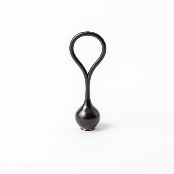 Black meditation bowl striker with looped handle and felt tip for gentle resonant sounds in prayer rituals.