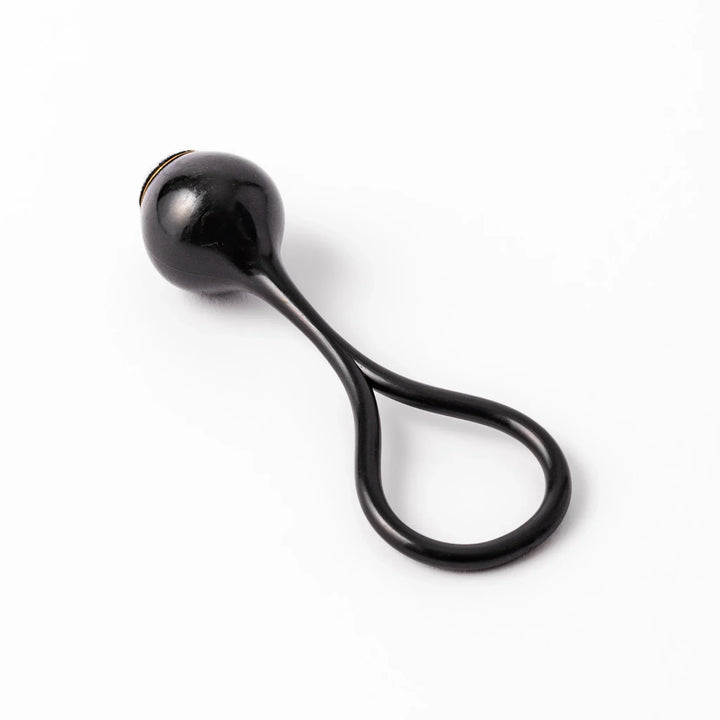 Black meditation bowl striker with looped handle and felt tip for gentle resonant sounds in prayer rituals.