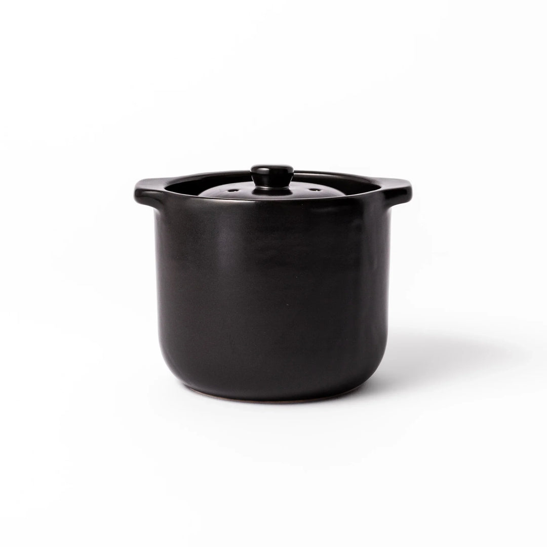 Black ceramic microwave rice cooker with double lid and handles for convenient cooking and table serving.