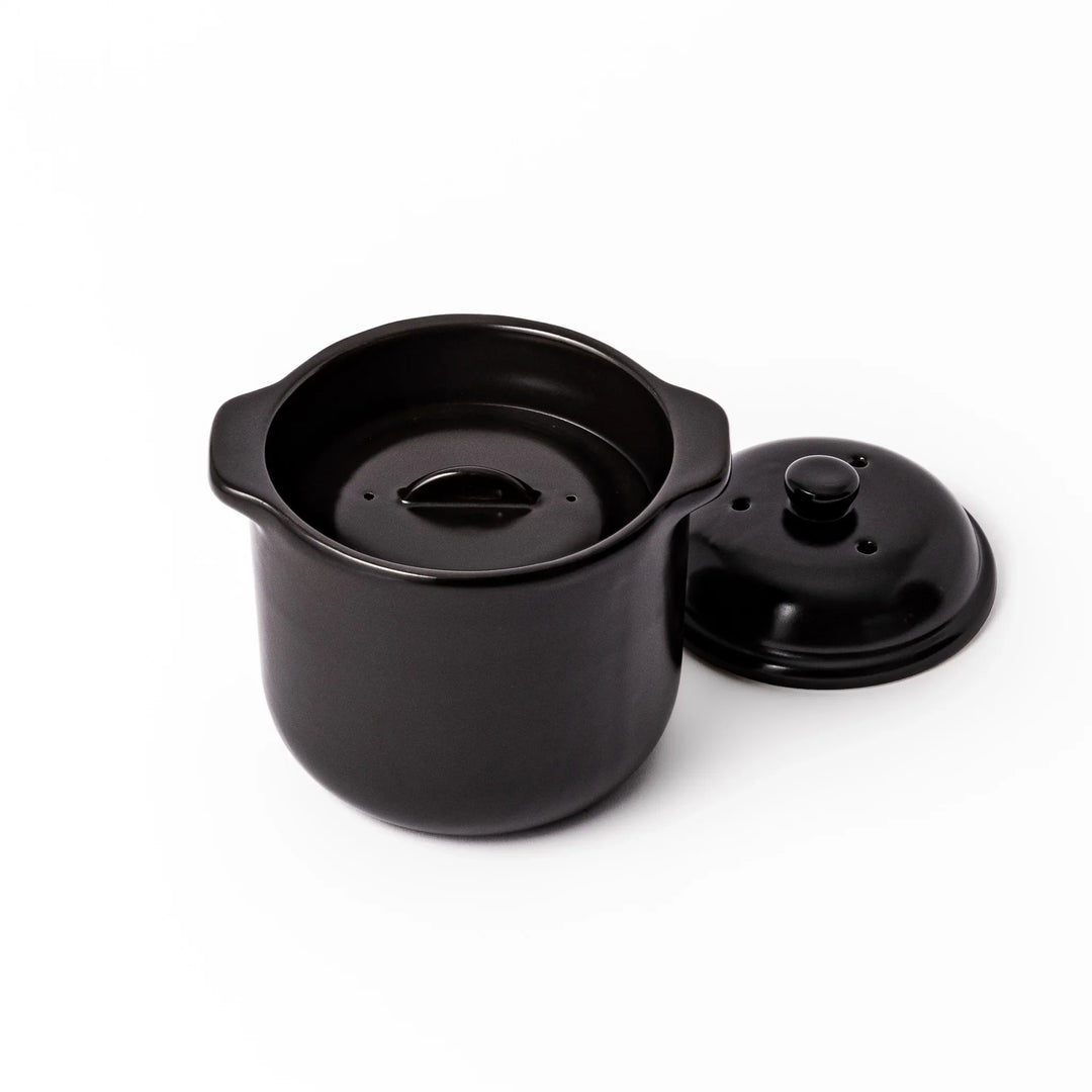Black ceramic microwave rice cooker with double lid and handles for convenient cooking and table serving.