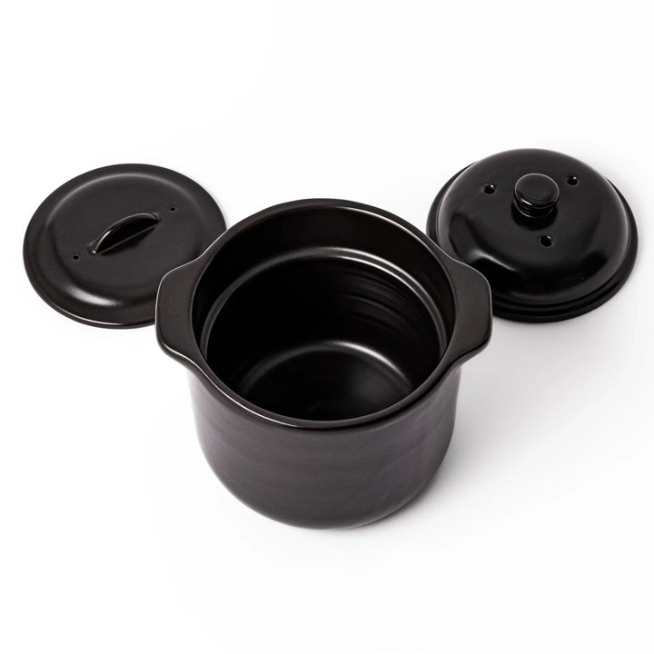 Black ceramic microwave rice cooker with double lid and handles for convenient cooking and table serving.