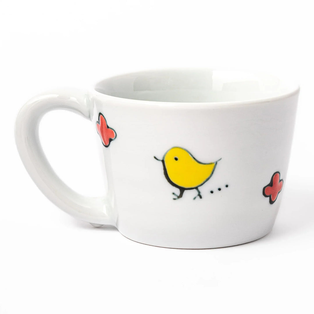 Children’s mug with hand-painted blue bird and musical notes, crafted from white porcelain for joyful sips.