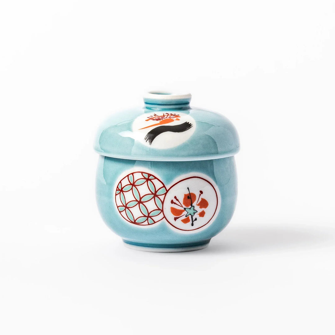 Lidded chawanmushi bowl with a glossy blue glaze and traditional red, black, and white circular patterns on lid and sides.