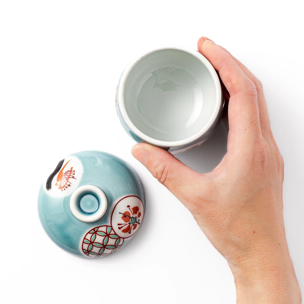 Lidded chawanmushi bowl with a glossy blue glaze and traditional red, black, and white circular patterns on lid and sides.