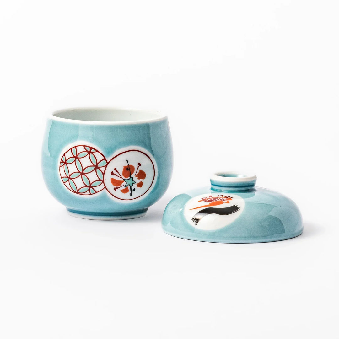 Lidded chawanmushi bowl with a glossy blue glaze and traditional red, black, and white circular patterns on lid and sides.