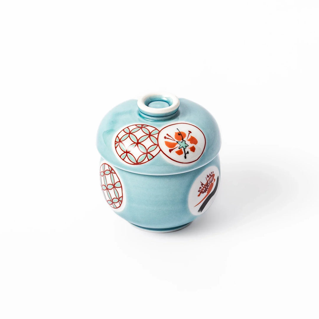 Lidded chawanmushi bowl with a glossy blue glaze and traditional red, black, and white circular patterns on lid and sides.
