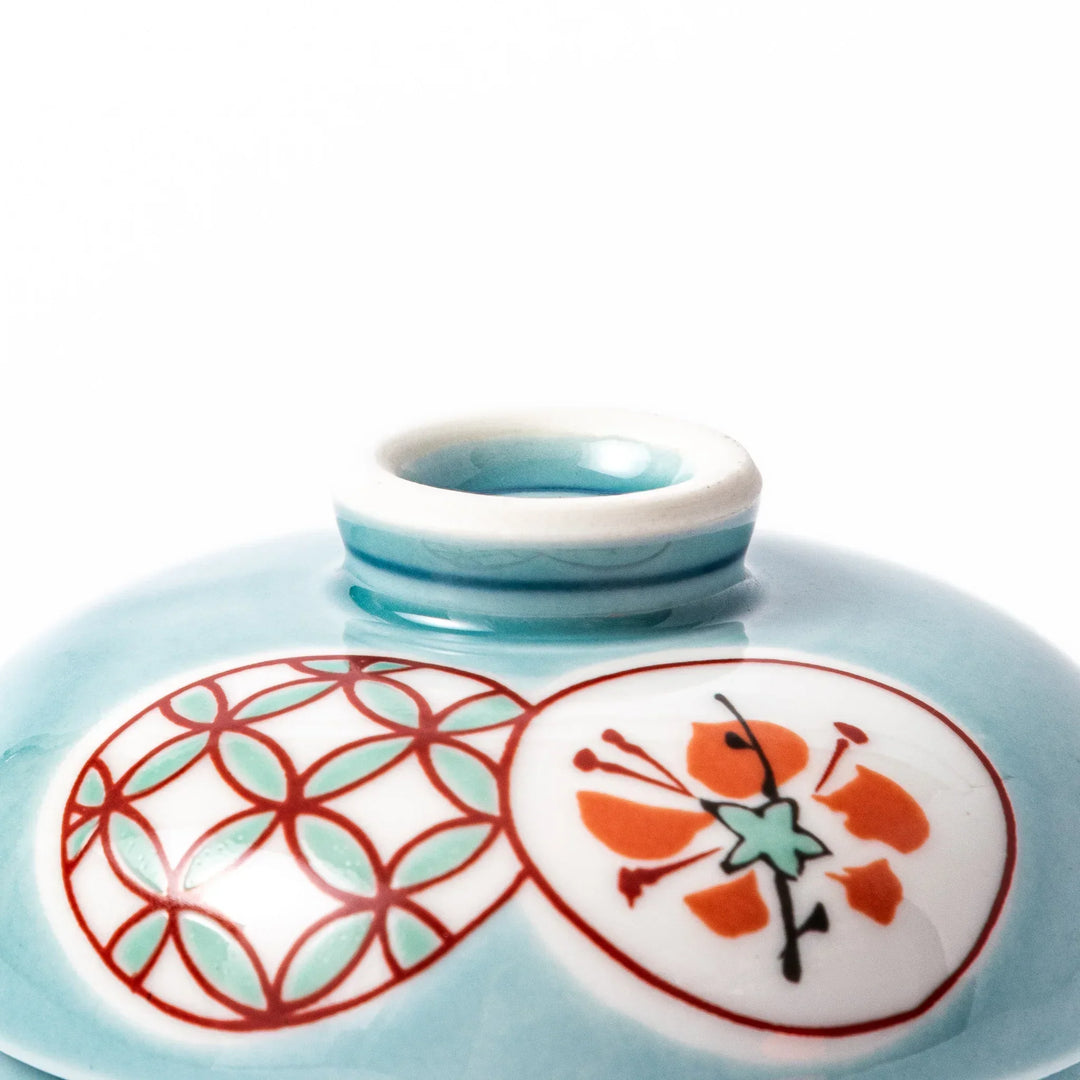 Lidded chawanmushi bowl with a glossy blue glaze and traditional red, black, and white circular patterns on lid and sides.
