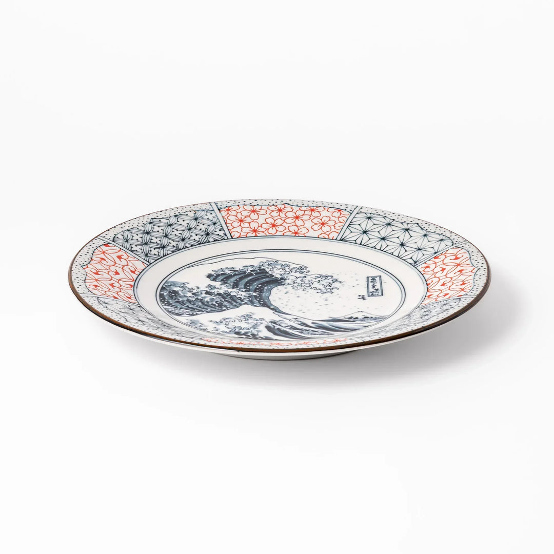 Japanese porcelain dinner plate featuring Hokusai Great Wave design with red and blue geometric border patterns.