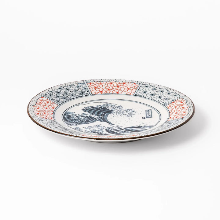 Japanese porcelain dinner plate featuring Hokusai Great Wave design with red and blue geometric border patterns.
